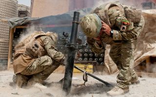 A mortar team fires on insurgents outside Forward Operating Base Khar Nikar in Afghanistan (Picture: MOD)