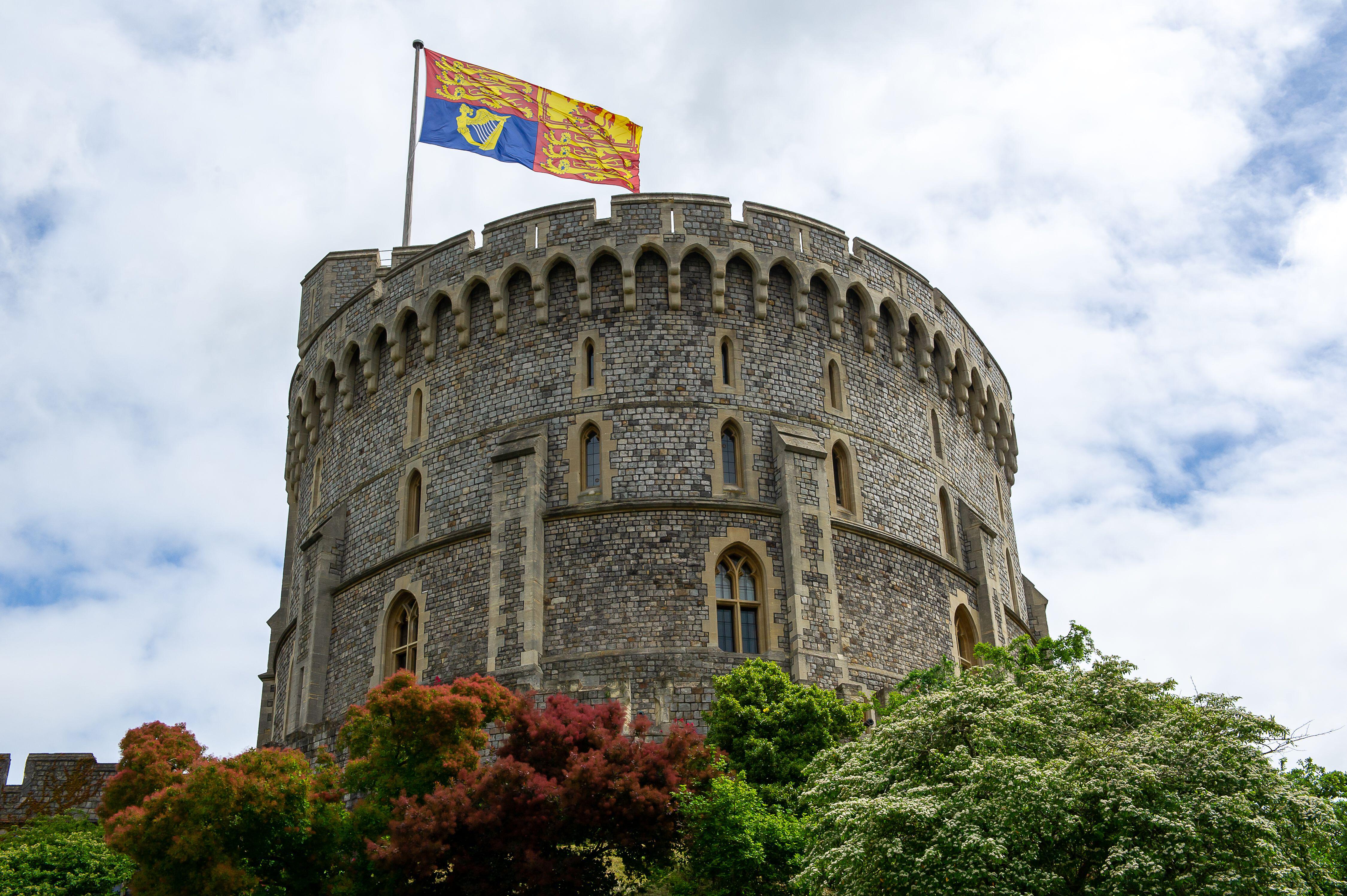 A large Royal Standard flag flies on the Round Tower at Windsor Castle